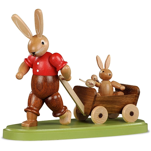 Easter bunny with child on wooden handcart, small colored-stained