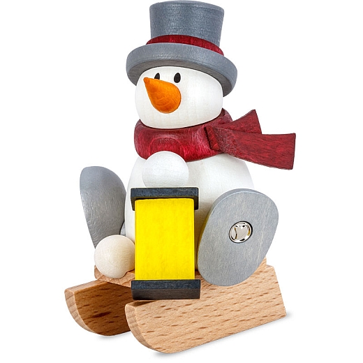 Snowman Otto with lantern on sledge