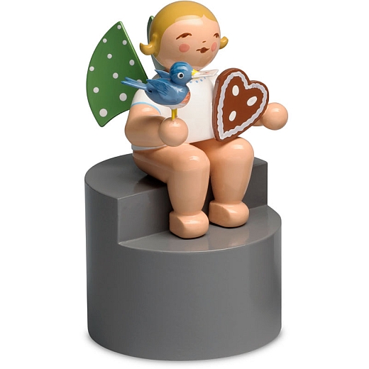 Angel with gingerbread and bird sitting on Pedestal